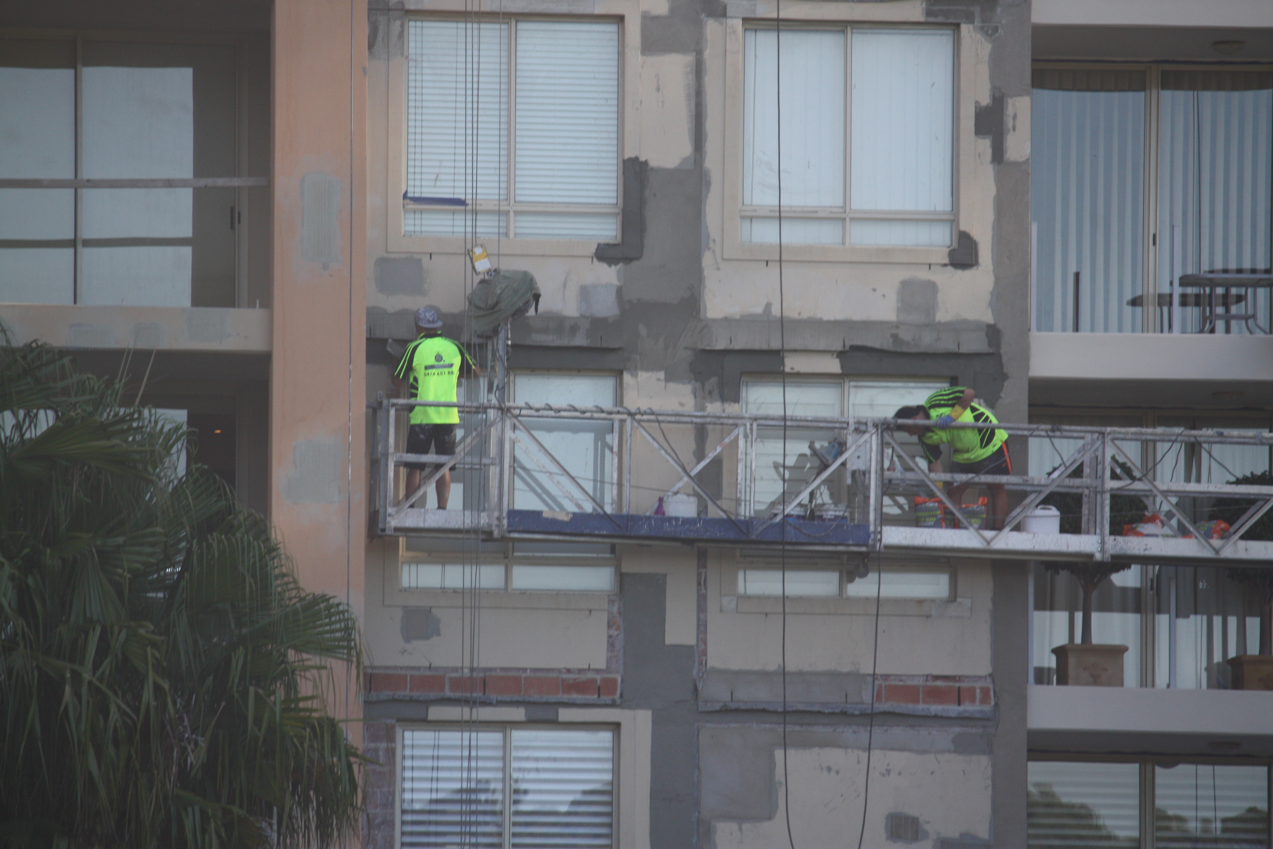 Two Builders On Scaffolding - Water Leakage Problem In Building - Remedial Building Services
